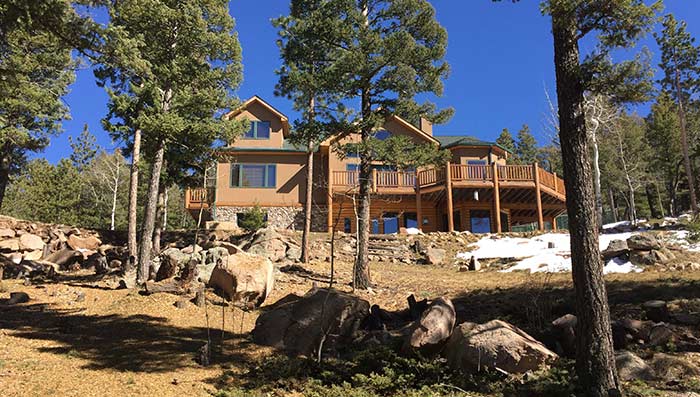 Mountain home with trimmed trees and cleared underbrush